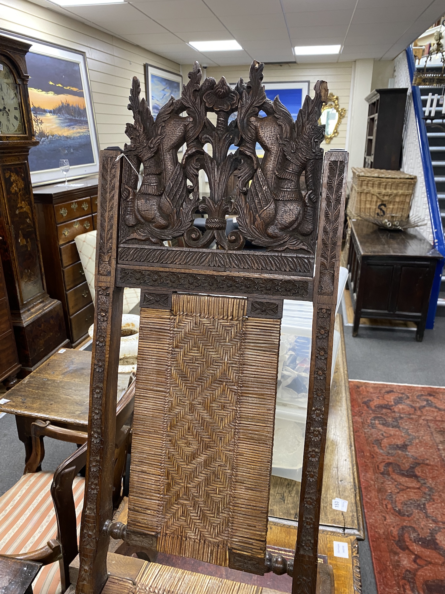 An Indian carved teak and rattan folding chair